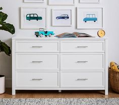 a white dresser topped with lots of drawers and pictures on top of it's sides