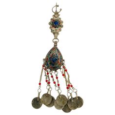 Beautiful vintage Moroccan ethnic fibula. A fibula was used to close a woman's veil in the Middle East and North Africa. Handcrafted by Berber and Nomadic Women from the High Atlas of Morocco. Total length: 10 in. tassels length: 3.5 in. Made of Moroccan silver ( not sterling) and adorned with enamel and beads and ancient coins. Moroccan Berber Tribal Tassel Fibula Pin with Coins and beads. Moroccan metal cloak pin Fibula with wirework and glass beads with open hoop attached on top; on bottom op Cloak Pin, Coral Colors, Moroccan Jewelry, Nomadic Women, Orange Coral, Ancient Coins, Traditional Jewelry, The Middle East, North Africa