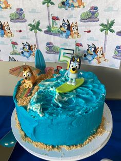 Bluey birthday cake beach theme sand waves Bluey Birthday Cake Beach, Bluey Birthday Cake 4, Bluey Pool Cake, Bluey Beach Cake, 2nd Birthday Bluey, Bluey Cake Ideas, Blue Y Bingo, Bubble Guppies Birthday Cake, Bluey Birthday Cake