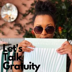 a woman holding up a sign with the words let's talk creativity