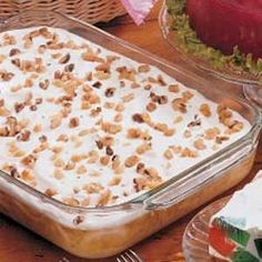 a casserole dish is sitting on a table with other dishes and utensils