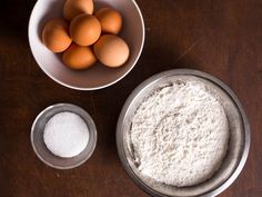 eggs and flour in bowls on a table