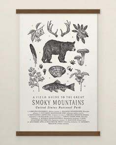 a black and white poster hanging on the wall next to a wooden framed sign that says smoky mountains