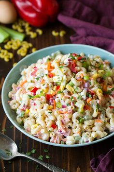 a bowl filled with macaroni salad on top of a table