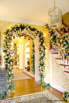 christmas decorations on the banisters and stairs in a home decorated with garland, ornaments and lights