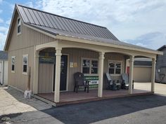 a small building with a porch and covered patio