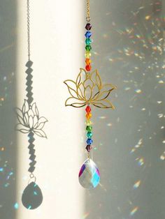 a wind chime hanging from the side of a wall with a flower on it