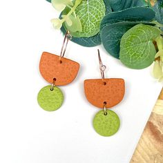 Burnt Orange & Pistachio Green Polymer Clay Hoop Earrings  Inject bold & vibrant colour to your look!  Measurements at widest & longest point (including hoops)  - 50mm long x 20mm wide.  This colour combination is: Main semi circle piece - Burnt Orange Small circle dangle piece - Pistachio Green 20mm diameter rose gold colour hoop Check out more colour block combinations in my Etsy shop  - https://www.etsy.com/uk/shop/KayJayClay Polymer clay is the perfect material for bold statement earrings as they are extremely lightweight so you can get the size but not the weight! If you have never tried them, you won't believe how comfortable they are.  A recent happy customer left this lovely 5 star review -  'These earrings are absolutely fabulous, if possible even better than the photo. I'm so thr Modern Handmade Green Hoop Earrings, Modern Small Green Hoop Earrings, Orange Pistachio, Orange Polymer Clay, Polymer Clay Hoop Earrings, Clay Hoop Earrings, Rose Gold Colour, 5 Star Review, Small Circle