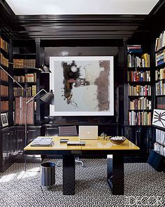 a home office with bookshelves and desk