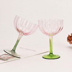 two wine glasses sitting next to each other on a table