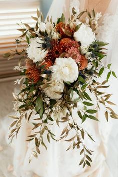 a bridal bouquet with white and red flowers