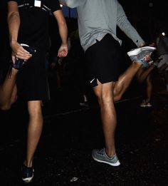 two people are playing frisbee in the dark