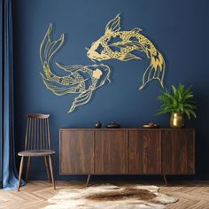 a blue room with two gold fish on the wall