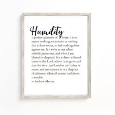 a framed print with the words humbly in black ink on white paper next to a wooden frame