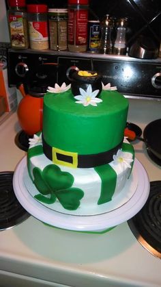 a green and white cake sitting on top of a stove