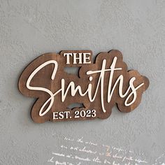 a wooden sign that says the smiths est 2093