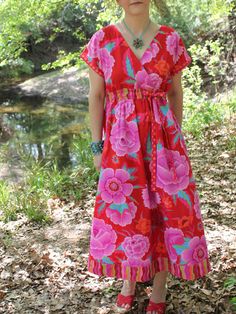 an image of a woman in a red dress with flowers on it and the words sew