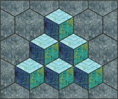 an image of a blue and green quilt with blocks in the center, on a gray background