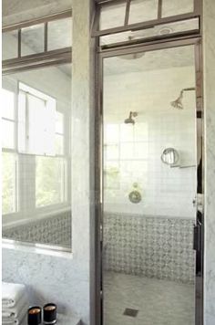 a bathroom with a large mirror and tiled walls