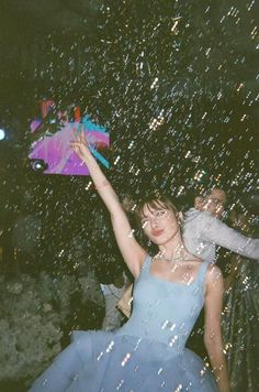 a woman in a blue dress holding an umbrella