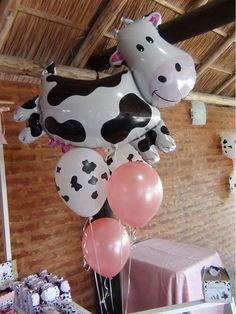 some balloons are in the shape of a cow