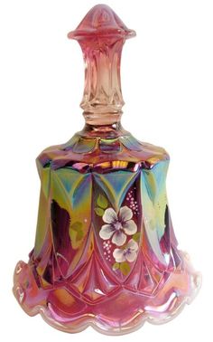 a pink glass bell with flowers on it