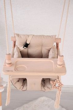 a wooden swing chair with cushions on it