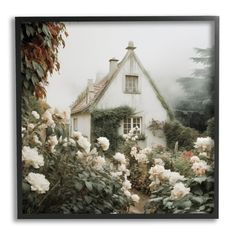 a white house surrounded by flowers and greenery on a foggy, overcast day