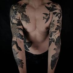 a man with tattoos on his arms and chest