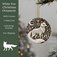 a white fox ornament hanging from a christmas tree