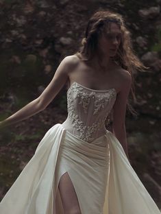 a woman in a white dress is walking