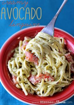 a red bowl filled with pasta and vegetables