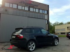 a black car parked in front of a building