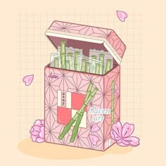 a pink box filled with lots of green bamboo sticks and bottles next to some flowers