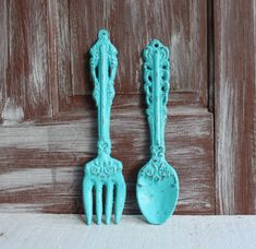 two blue plastic utensils sitting next to each other