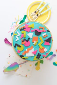 a birthday cake decorated with confetti and colorful icing on a white surface