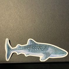 a sticker of a whale shark on a laptop