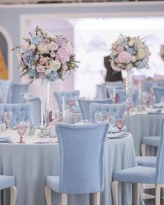 the tables are set with white and blue linens