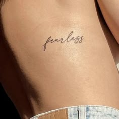 a woman's back with the word fearless written on it