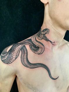 a man with a snake tattoo on his chest