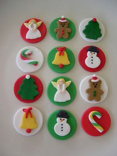 twelve decorated christmas buttons on a white surface