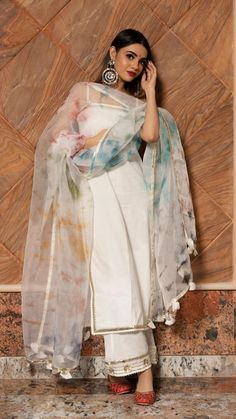 Make an everlasting, eternal impression at any upcoming festive occasion in this white cotton suit set with beautiful multi color dupatta comparising with beautiful gotta lace boarder.The suit set features an overall gotta patti lace work,The multi color organza dupatta comes with an gotta lace border and tassel detailing around the edges. This is a great pick for the festive season! SKU#: 11403157WH Disclaimer: There may be slight difference in actual product color compared to product images. White Chanderi Palazzo Set For Diwali, White Organza Palazzo Set With Chikankari Embroidery, Diwali White Chanderi Palazzo Set, White Unstitched Suit With Gota Work For Eid, White Chanderi Palazzo Set With Gota Work, White Cotton Silk Sharara With Straight Kurta, Festive White Palazzo Set With Sheer Dupatta, White Palazzo Set With Sheer Dupatta And Straight Kurta, White Anarkali Palazzo Set With Sheer Dupatta