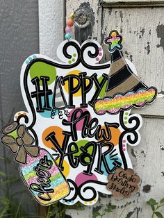 a happy new year sign hanging on the side of a door