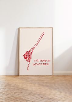 a red and white poster with the words nothing is impastable on it next to a wooden floor