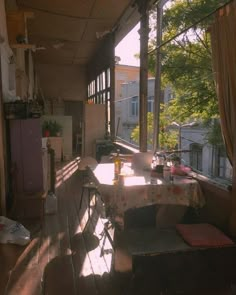 the sun shines through the windows in an empty room with tables and stools