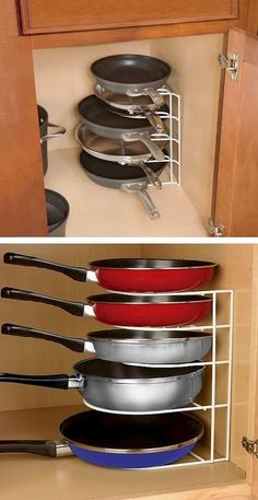 there are many pans stacked in the kitchen cabinets and one is on the bottom shelf