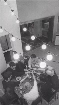 a group of people sitting around a table eating food