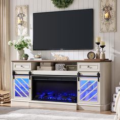 an entertainment center with a fireplace and television on it's stand in a living room