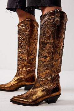 Have a major moment in these tall metallic cowboy boots. **Features:** Tall style, pull-on design, leather uppers, pointed toe, crinkled metallic finish, embroidered details, dipper toplines, pull straps, block heel **Why We | Moody Metallic Cowboy Boots by FP Collection at Free People in Gold, Size: US 8 Gold Cowboy Boots, Metallic Cowboy Boots, Snakeskin Cowboy Boots, Bear Leather, Hunter Wellies, Metallic Boots, Black Cowboy, Mens Cowboy Boots, Western Boots Women