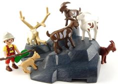 small toy figurines are standing on top of an ice floet with animals